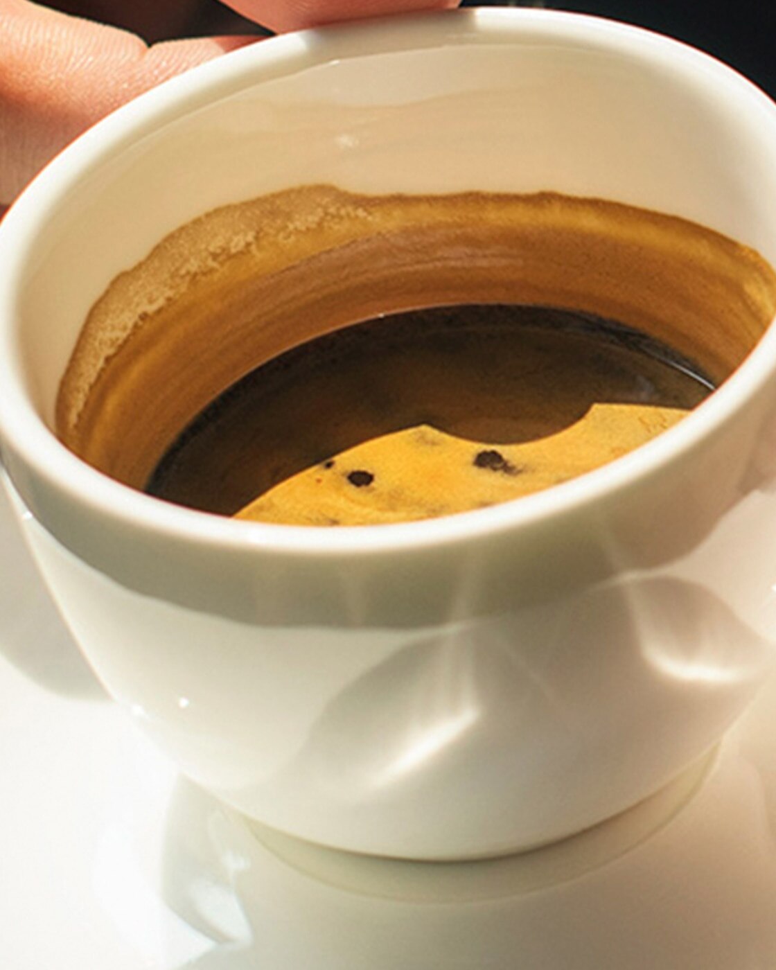 A woman enjoying an Espresso in an outside café