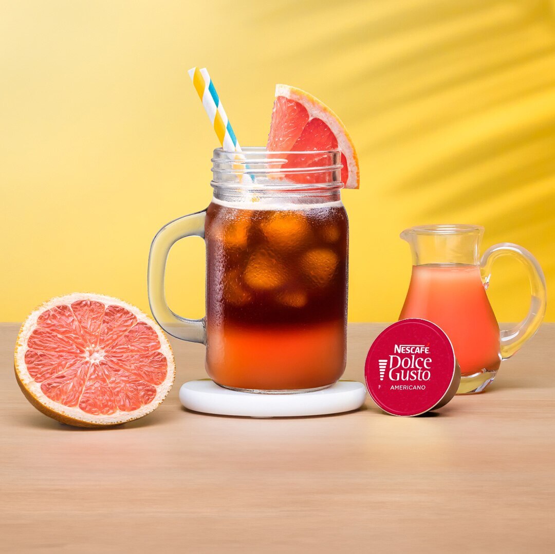 iced grapefruit next to a coffee capsule