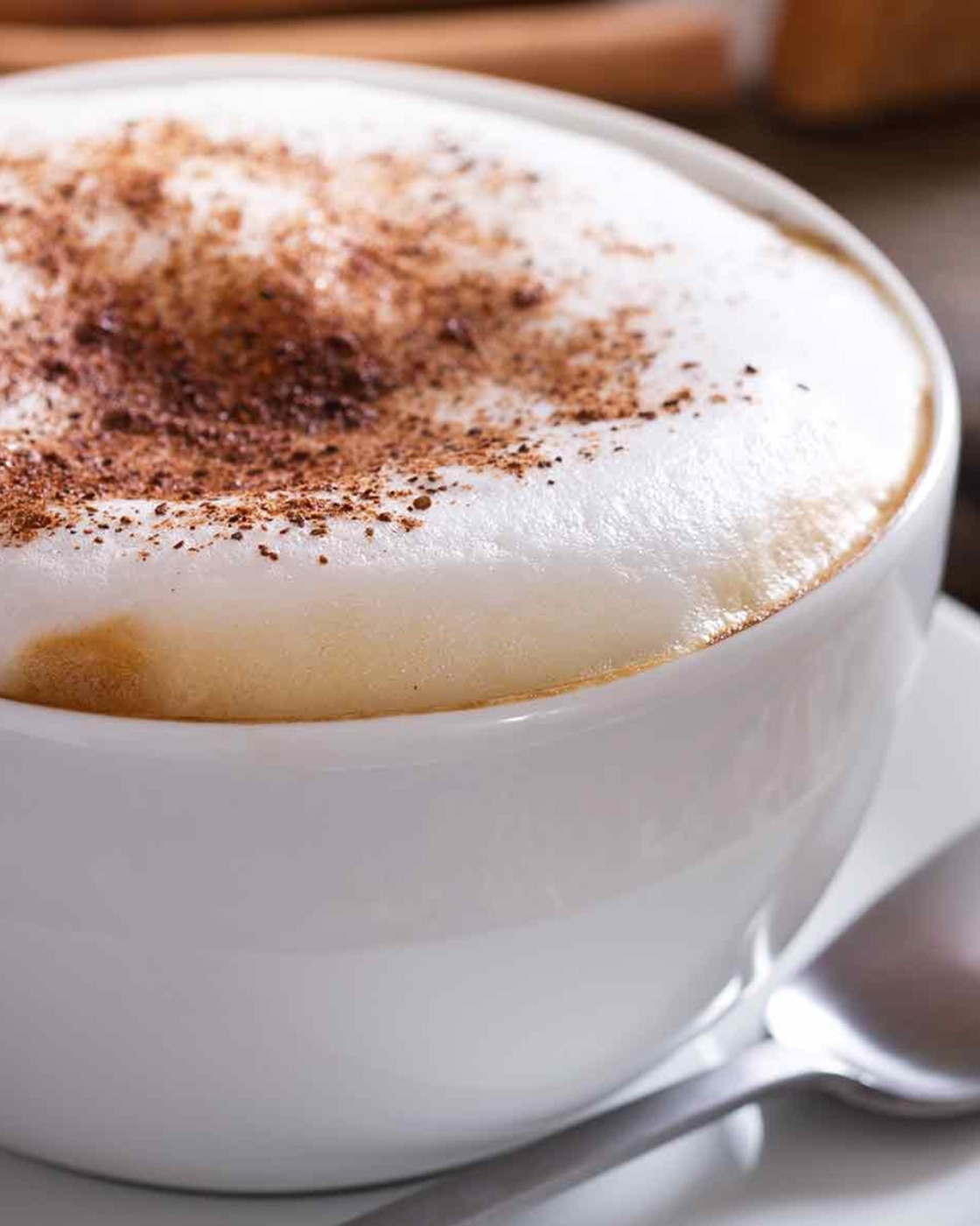 Hands holding cup of black coffee